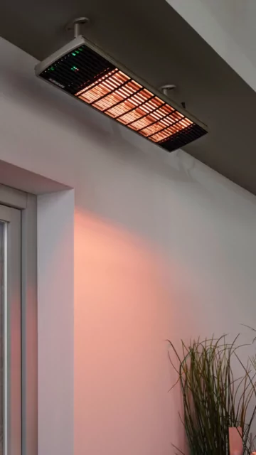 Heatscope Heaters Spot 2800W Radiant Heater wall-mounted on a restaurant terrace, outdoor electric infrared heating in Commercial Space.