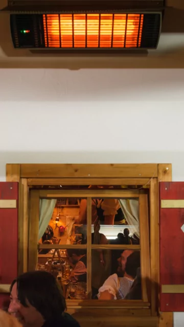 Heatscope Heaters Spot 2800W Radiant Heater wall-mounted in a commercial restaurant, indoor electric infrared comfort.